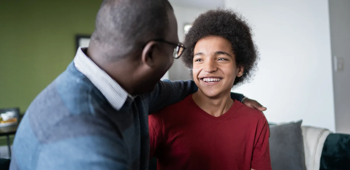 Father and son smiling at each other
